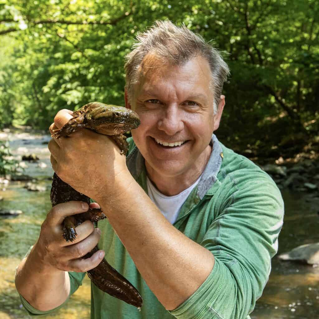 Chris Kratt holding hellbender salamander