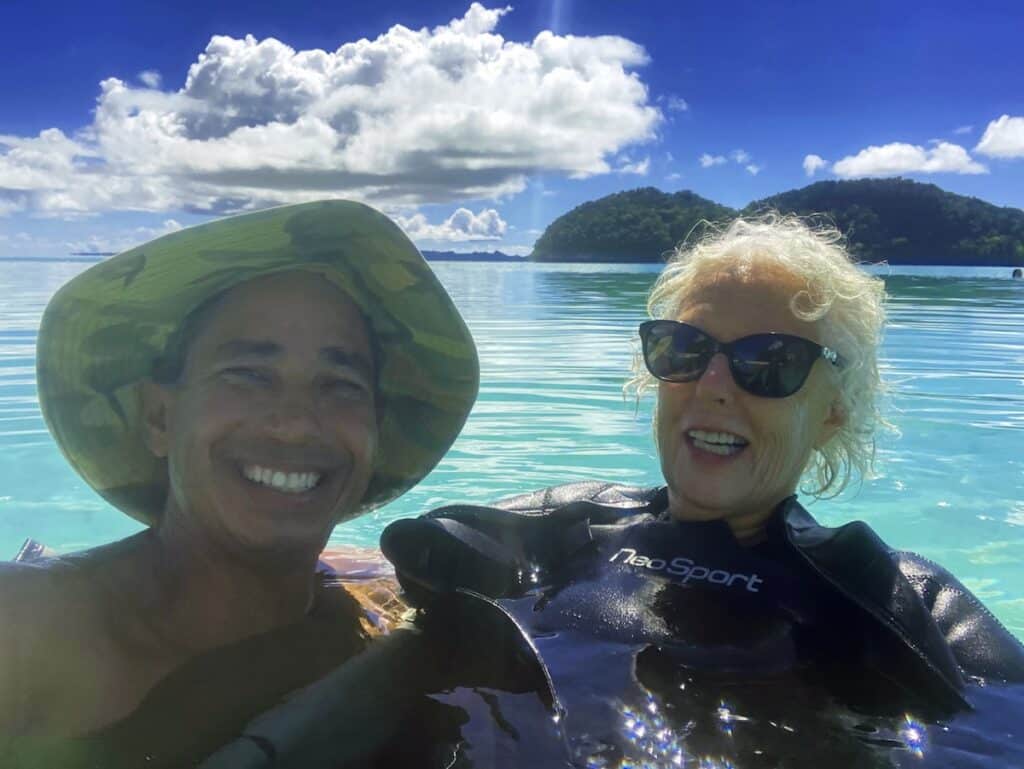 snorkelers pose in turquoise water in Palau
