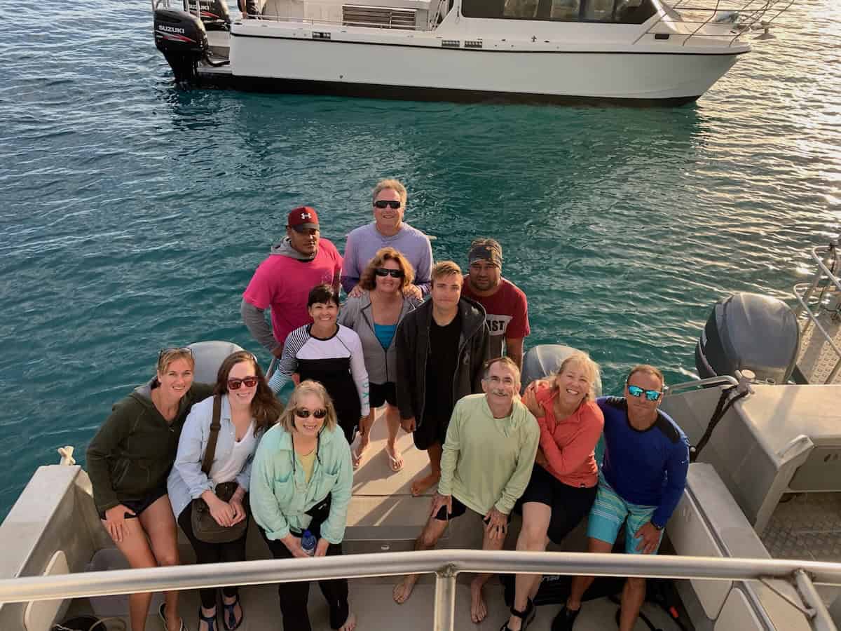 Travelers posing on boat stern in Tonga